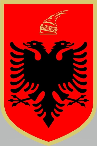 Albania’s coat of arms was adopted in 1998 and features its national symbol, the double-headed black eagle, with the national colors of red and black. Red represents the courage and strength of the Albanian people, and the golden border represents the country’s wealth. The helmet above the eagle is modeled on the helmet of Skanderbeg, a 15th-century Albanian military hero who led a rebellion against the Ottoman Empire. The goat on top of the helmet represents defiance and resistance.